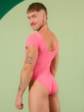 Person wearing a pink bodysuit against a light green background