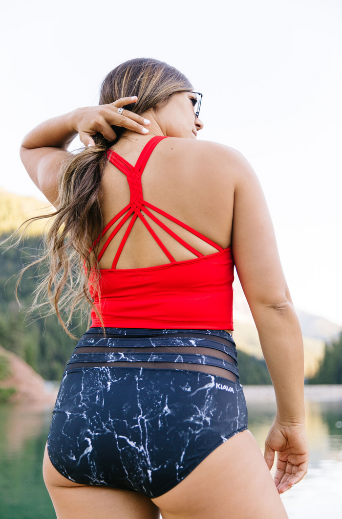 Olivia is wearing large bottoms & a medium top. She is a size 10, 5'8" and a 34D.