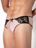 Man wearing pink underwear with black lace details on a white background
