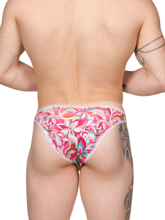 Rear view of a male model wearing pink floral panties with white lace trim