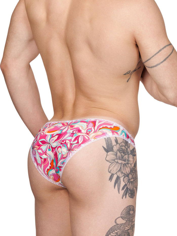 Rear view of a male model wearing pink floral panties with white lace trim