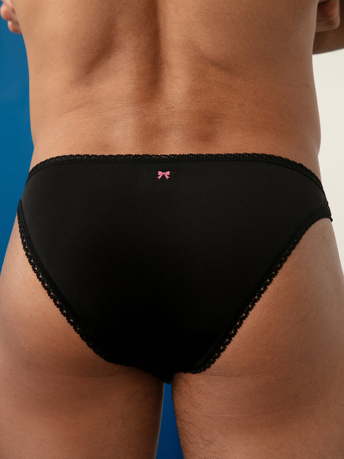Closeup rear view of a man wearing black panties.