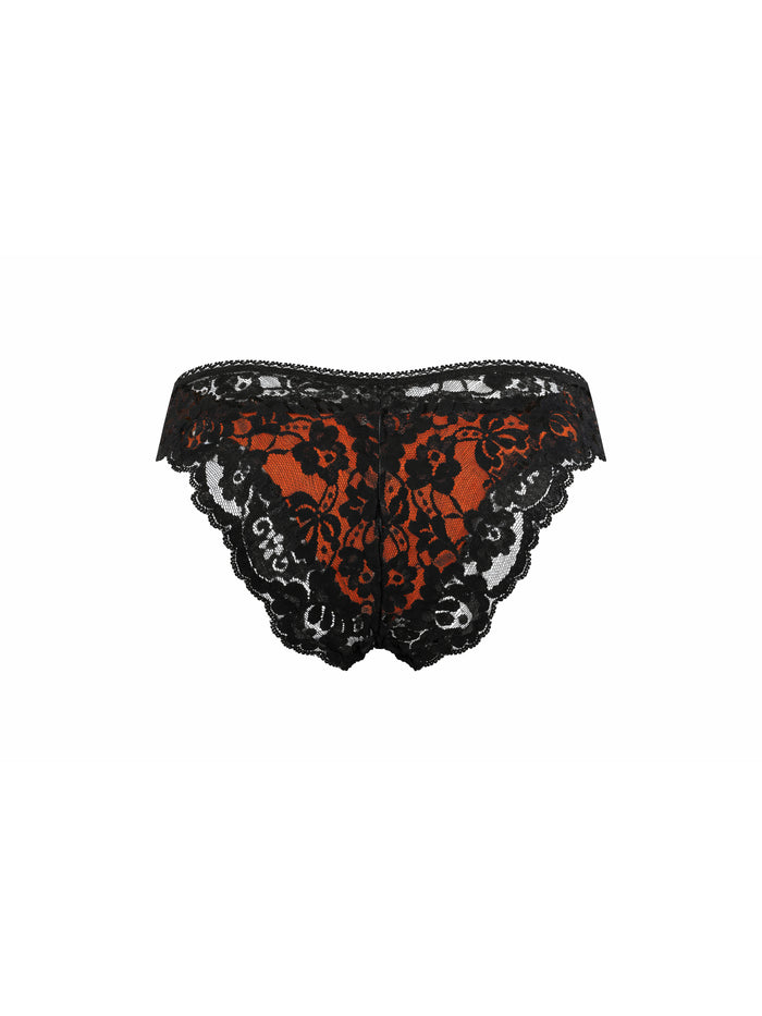 Rear view of an orange satin men's panty with black lace, on a white background.