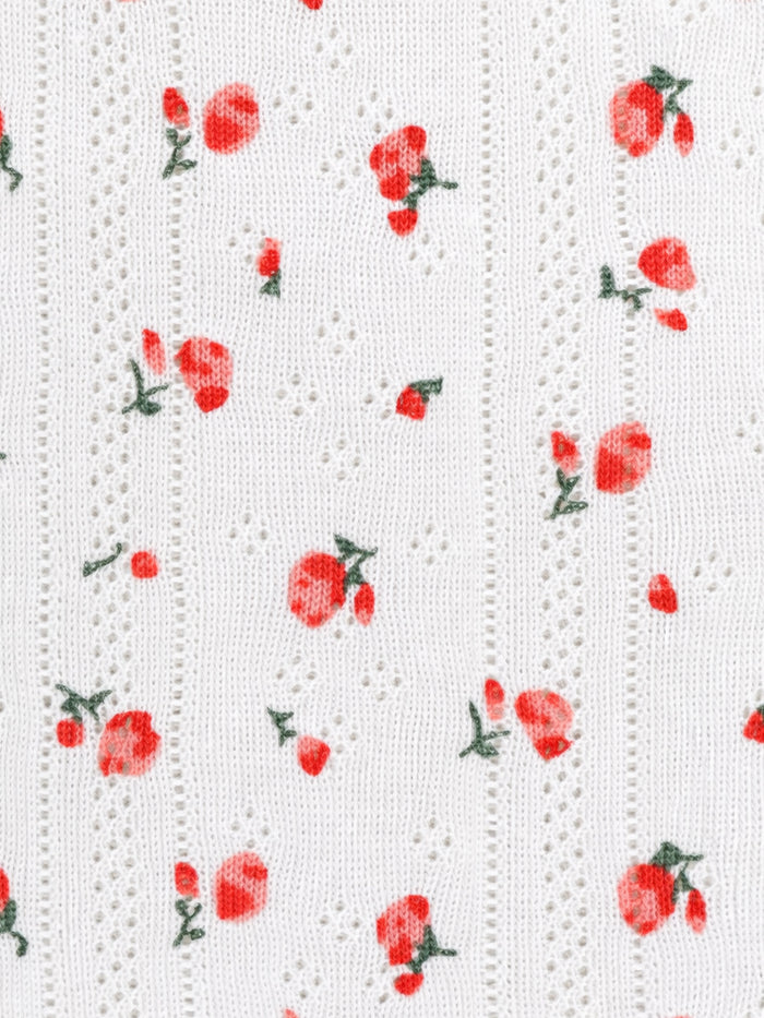 White textured fabric with red floral pattern
