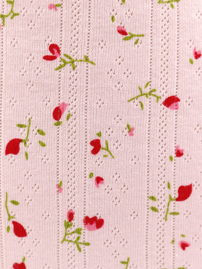 Pink fabric with red floral pattern