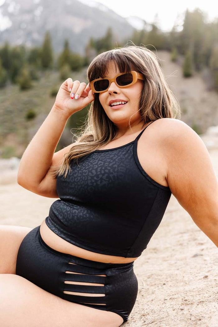 Switchback crop top with small straps in front and criss cross in back in black with stealthy leopard print