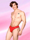 Side view of a male model wearing an XDress red lace thong with black picot trim