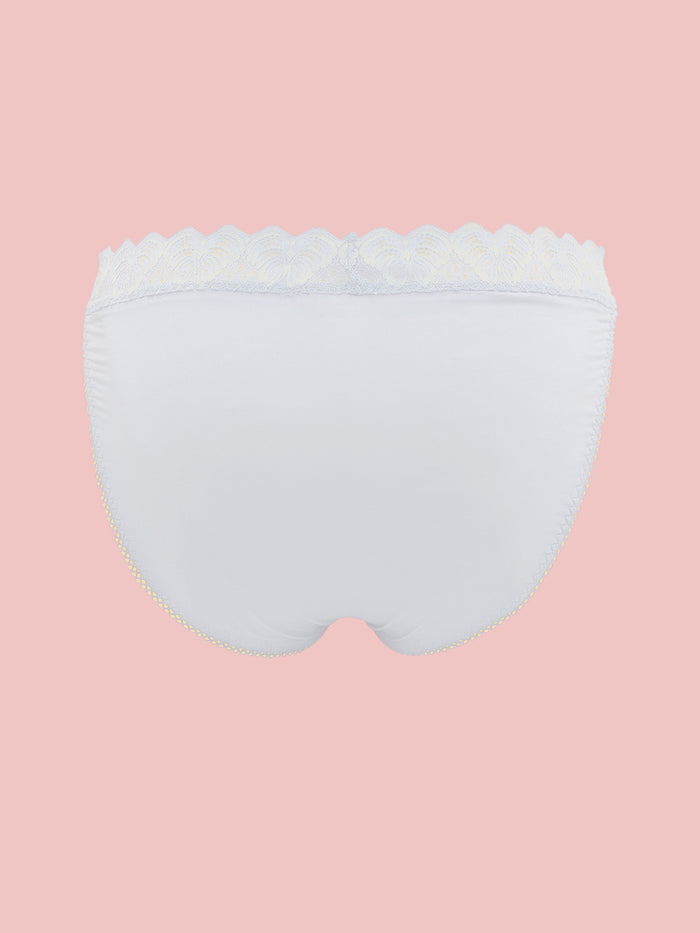 White men's panties with lace trim on a pink background.