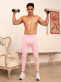 Front view of a man wearing pink cotton leggings, holding dumbbells.